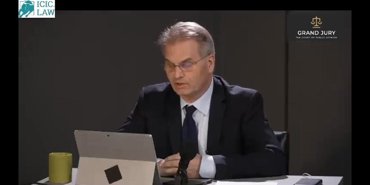 Reiner Fuellmich at a desk during the 2022 Grand Jury: The Court of Public Opinion broadcast.